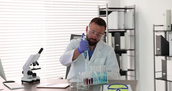 Research in genetics. Scientist with micropipette and microplate working at table in laboratory