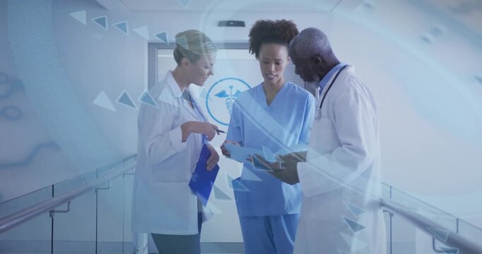 Female doctor pointing at nurse chart while male doctor highlighting tablet data for record review