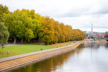 Fototapeta premium A landscape view with the River Trent in Nottingham and Trees in autumn colour along the embankment.