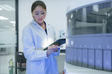 A scientist of the future reviews multiple experimental paths suggested by an AI on her tablet, using her human expertise to select the most promising hypothesis for the next automated test.