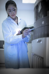 A scientist of the future reviews multiple experimental paths suggested by an AI on her tablet,...