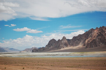 Vast arid landscape with rugged mountains under a clear blue sky
