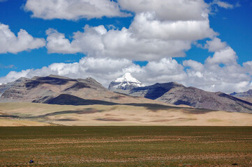 Fototapeta premium Magnificent mountain landscape with snow-capped peak under blue sky
