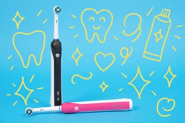 Black and pink electric toothbrushes stand against a blue background with playful dental care symbols, oral hygiene importance.