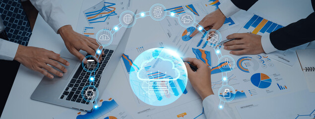 Business professionals engage in data analysis with charts and graphs in a modern workspace, highlighting teamwork and technology in a dynamic setting. Trope