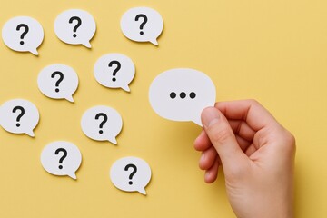 Conceptual Composition of Question Marks and a Thinking Speech Bubble Against Yellow Background