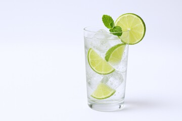 Fototapeta premium Refreshing Lime Cocktail with Ice and Mint in Tall Glass on White Background
