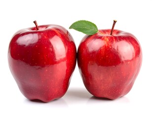 Two glossy red apples, one leaf