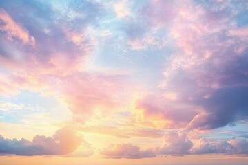 Fototapeta premium Vibrant colorful sky with soft pastel pink, purple, blue, and orange clouds during a serene sunset or sunrise