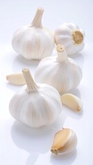 White garlic bulbs arranged in a studio setting