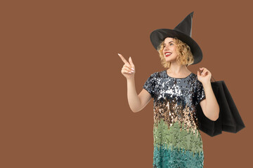 A stylish woman in a witch costume joyfully celebrates Halloween