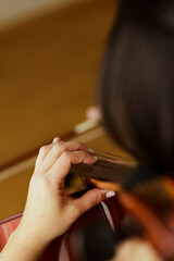 Cello player bow on strings close up