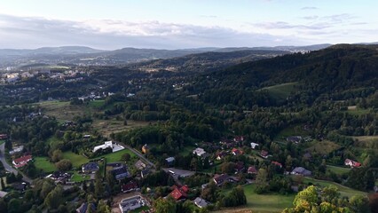 A stunning aerial view showcasing serene landscapes filled with rolling hills and charming houses