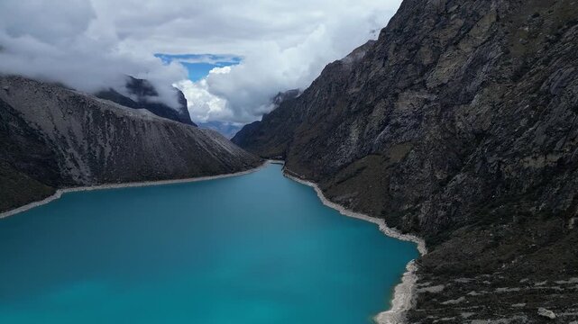 Huaraz, Peru:  Laguna Paron shot by drone. With forward motion showing dramatic sky and the valley of biggest mountain lake in Cordillera Blanca in Caraz of Huaraz region, Peru
