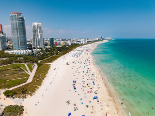 Miami beach with turquoise waters. Aerial view of sandy coastline and waves. Tropical Miami Beach...
