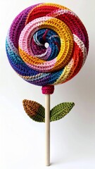 Colorful Crocheted Lollipop with Wooden Stick and Two Leaves on White Background