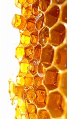Golden Honeycomb Drips in Golden Light on White Background Detail