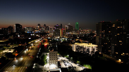 Obraz premium Amazing aerial drone photograph of Dallas city skyline. Photo taken at dawn during the golden hour. View of traffic and buildings lit and the orange glowing of the rising sun.