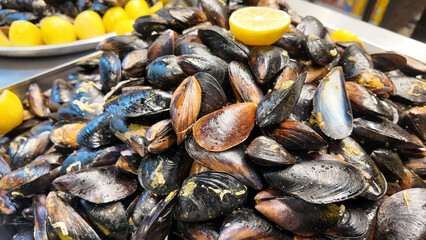 Fresh mussels served with lemon on a tray