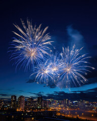 Fototapeta premium Fireworks display lighting up night sky above vibrant city skyline with illuminated buildings and streets