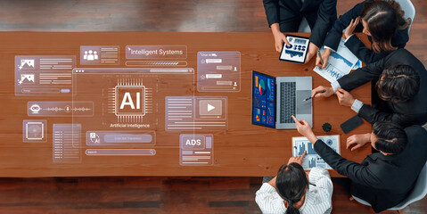 A business team collaborates on an artificial intelligence project, analyzing data on tablets and discussing innovative solutions in a modern workspace. Trope