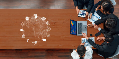 Diverse professionals engaged in a collaborative project in a modern workspace, utilizing digital tools to analyze data and strategize for financial insights. Trope