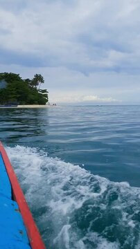 Tour boat heading to Angso Duo Island under cloudy sky Pariaman Indonesia