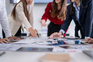 Business people analyzing charts and graphs, developing corporate strategy