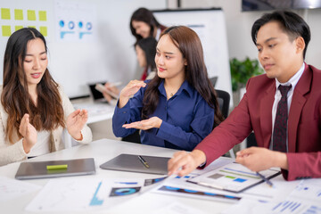 Business team analyzing financial documents and discussing growth strategies in office meeting