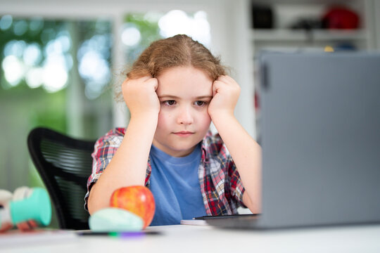 Child on online school lesson at home. Kid learning on laptop e-learning. Teen student learn lesson on laptop. Teenager study remotely using laptop. Teen student doing homework during online lesson. - Powered by Adobe