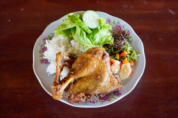 Fried Duck with Black Spices, captured on October 9, 2025. Crispy duck richly seasoned with aromatic black spices, paired with spicy green chili sambal and fresh sambal matah, authentic Indonesian cul