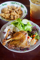 Fried Duck with Black Spices, captured on October 9, 2025. Crispy duck richly seasoned with aromatic black spices, paired with spicy green chili sambal and fresh sambal matah, authentic Indonesian cul