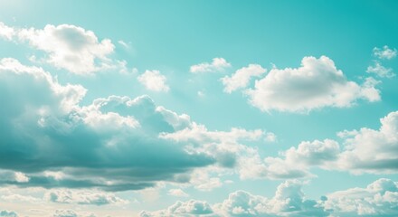 Ethereal cumulus clouds drift across a serene turquoise sky, creating a dreamy, atmospheric vista