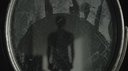 Eerie silhouette reflected in vintage mirror with scratches and dust for haunted house or thriller movie scene, conveying mystery