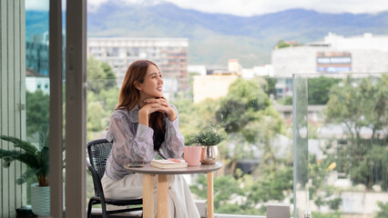 Adult Asian woman enjoy morning calm peace home balcony city mountain view thoughtful reflection contemplation tranquil urban scenery outdoor living space