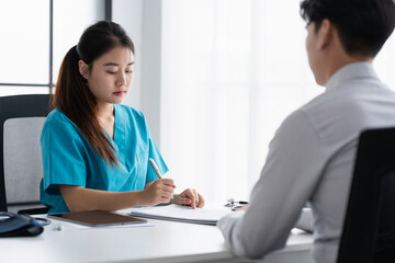 Doctor Filling Patient Medical Records at Hospital