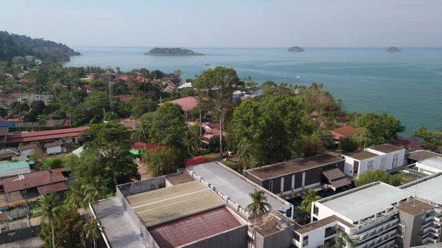 aerial footage of Kai Bae village on Koh Chang island with hotel accommodation, ocean and islands