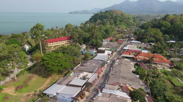aerial drone footage of Kai Bae village on Koh Chang island with hotel accommodation mountains and ocean