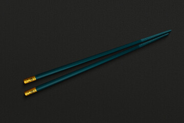 Pair of reusable chopsticks on dark background