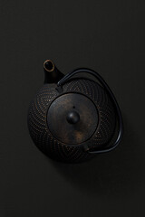Metal teapot on dark background