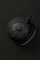 Metal teapot on dark background