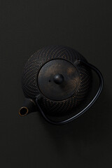 Metal teapot on dark background