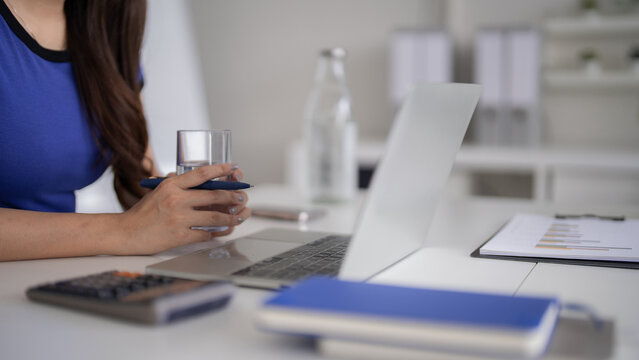 Asian woman work laptop office desk business strategy data analysis professional remote financial wellness productivity focus