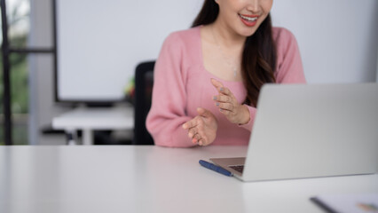 Adult Asian business woman cheerful online video call professional discussion remote workspace modern home office digital communication technology use