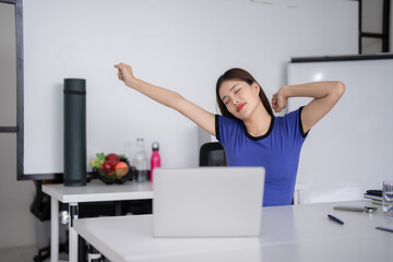 Asian businesswoman adult woman stretching office desk laptop computer break healthy workspace wellness professional relief posture exercise