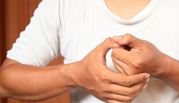 Close-up Of Man Hands Cracking His Knuckles At Home. Bad habit