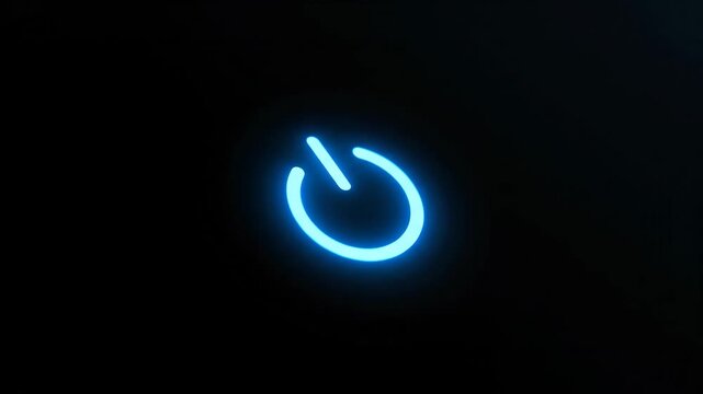 Illuminated Power Button on Black Background - A close-up shot features a bright blue illuminated power button against a deep black background.