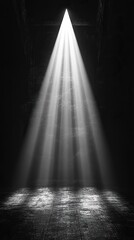 A beam of bright light streaks down through an open space. It illuminates the textured ground