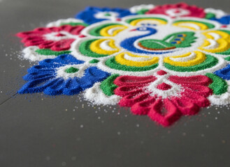 Close-up of a vibrant and intricate rangoli with a peacock design, made with colored powder for the Diwali festival.