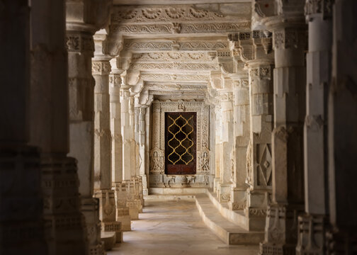 Historic Jain temple corridor with detailed intricate architecture in Ranakpur, Rajasthan, India. Built in 1496.